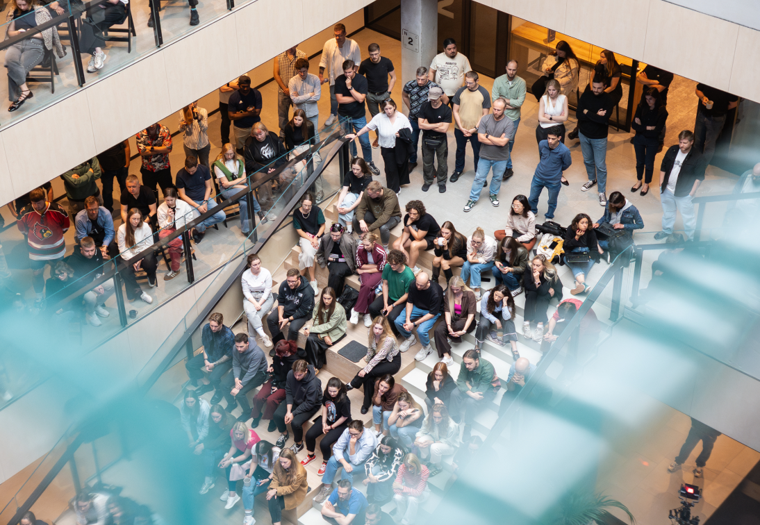 Nord Security employees gathered on the office atrium stairs.