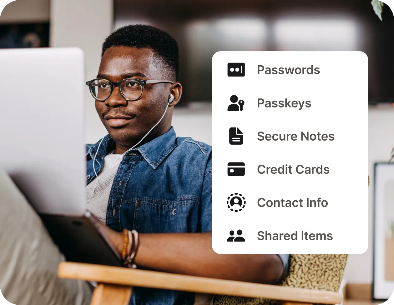 Man using a laptop with a sidebar showing options: Passwords, Passkeys, Secure Notes, Credit Cards, Contact Info, Shared Items.