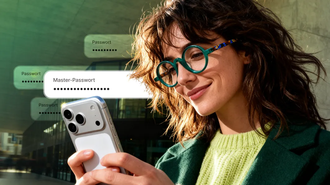 Person mit türkisfarbener Brille, die ein Smartphone benutzt, auf dessen Bildschirm die Benutzeroberfläche eines Passwort-Managers angezeigt wird.