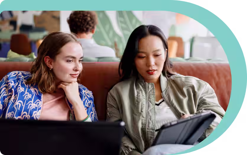 two women on sofa using nordpass on their ipad
